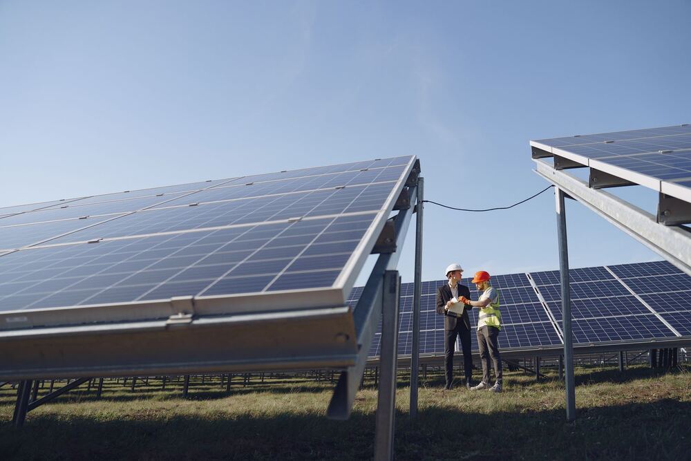 Two engineers discussing a project at a solar farm